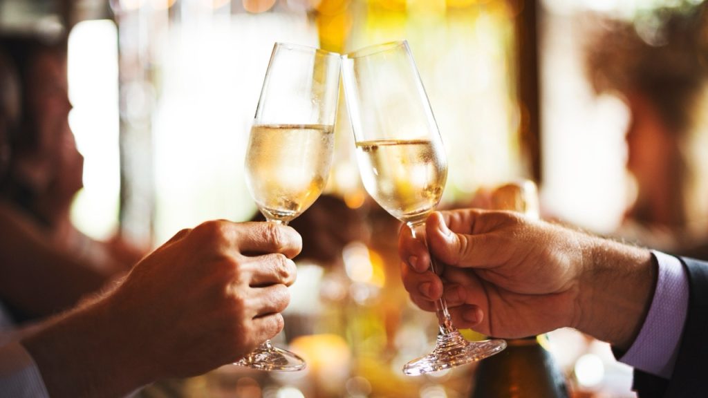 Two people enjoying a glass of prossecco at lunch in Hatton Court Hotel on a Lazy Sunday offer.