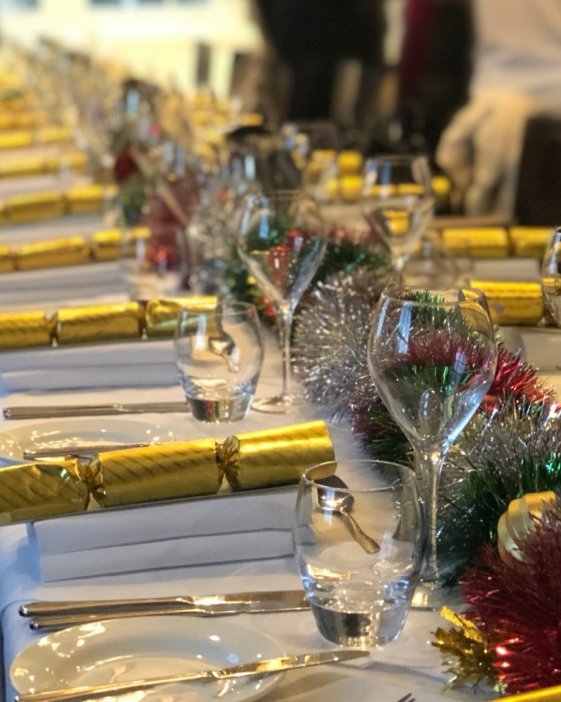 Table set up for christmas dining with crackers