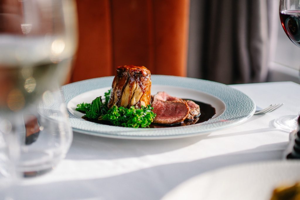 Pan fried venison haunch steak with game suet pudding, kale and blackbrerry jue.