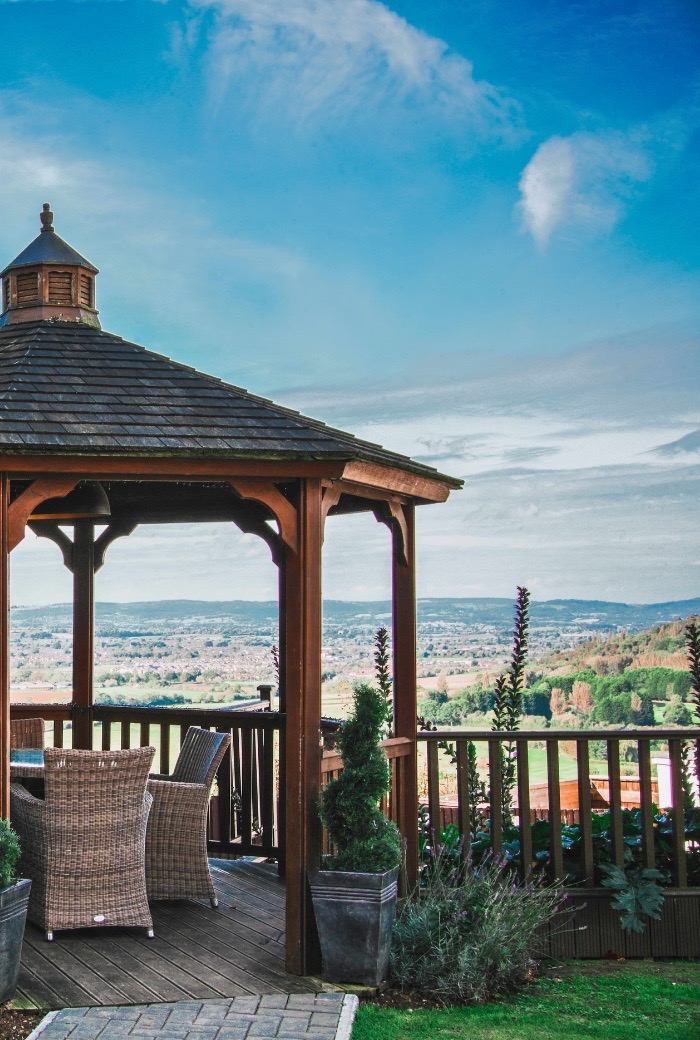 Hatton court pergola in the summer over looking the seven vale