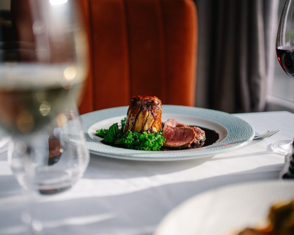 Game suet pudding with venison, fresh spring greens and blackberry jus.