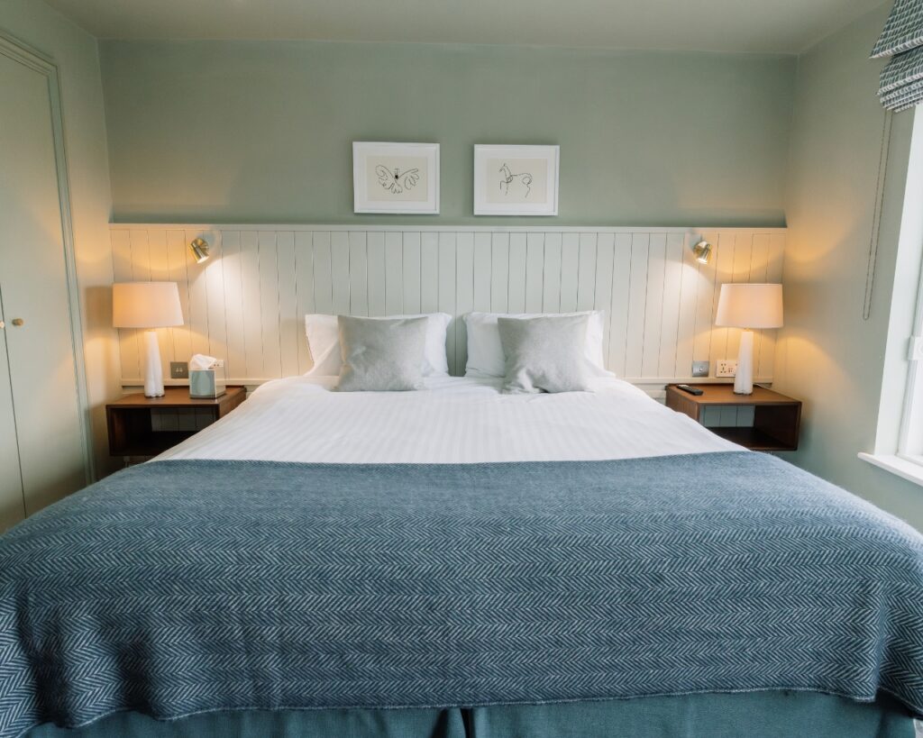 Newly refurbished heritage room at Hatton Court Hotel with a king-sized bed.